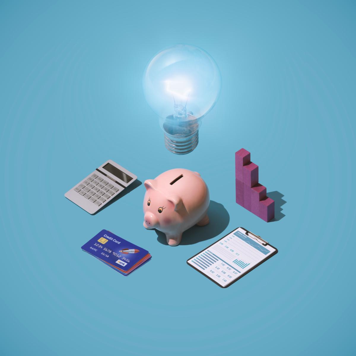 Business planning strategies ideas and solutions piggy bank with lit bulb credit cards and financial items
