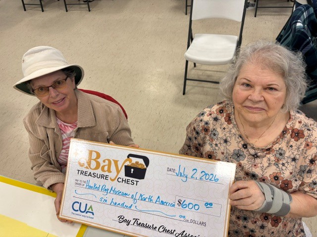 volunteers for the count holding an oversized honorarium cheque
