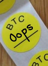 BTC sticker with the word oops written on it