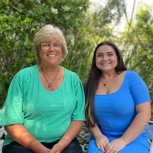 Marsha and Karlee sitting on a garden bench