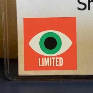 Photo of a limited vision alert sticker on someone's name tag