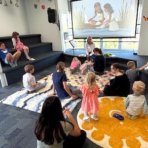 Children's Ministry teacher and children learn about the Exodus story