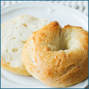 Photo of a bagel on a white plate