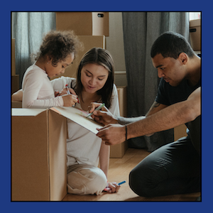 Stock photo of a diverse family with moving boxes