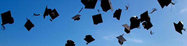 Graduation hats being thrown in the air