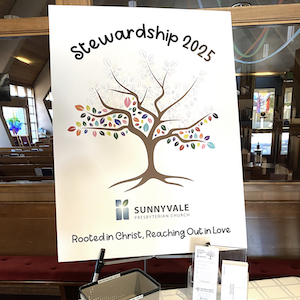 Photo of the Stewardship 2025 tree poster with half its leaves filled in
