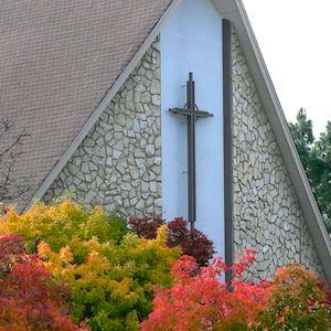 Front of the church with trees turning fall colors