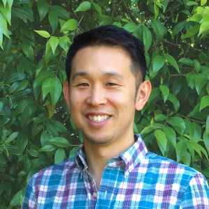 Hardy Kim smiling headshot against a green leafy background