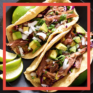 Close-up of steak tacos with lime and avocado 