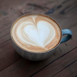 Stock photo of a coffee mug with a heart shape latte art on top