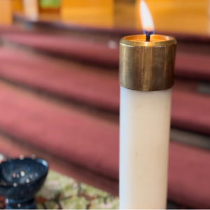 Photo of a candle on the table in the sanctuary