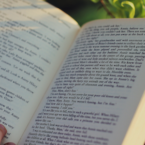 Close-up photo of a book being read outdoors