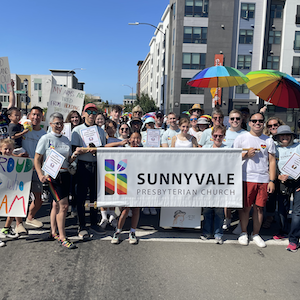 SVPC at Silicon Valley Pride Parade 2024 groupshot standing behind the church banner
