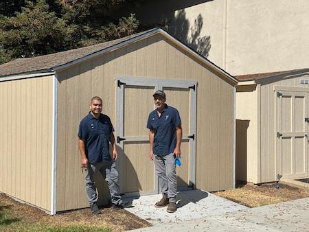 Jose and Game standing in front of the newly built shed
