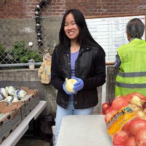 Photo of Alice Chegwidden sorting produce during CARAVAN 2025
