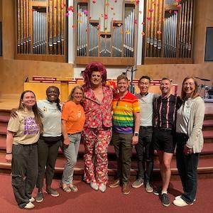 Groupshot of SVPC church staff with Flamy Grant in the sanctuary