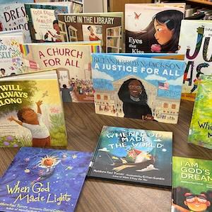 Children's book covers arranged on a library table