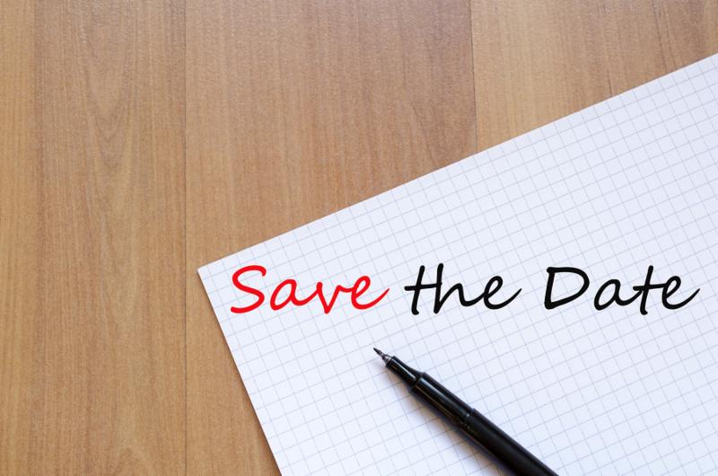 White blank notepad on office wooden table Save the date concept