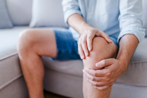man massaging arthritic knee