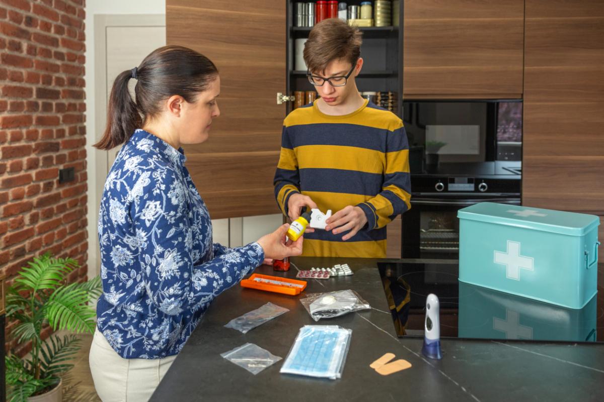 Young man learning about pharmaceuticals with older woman