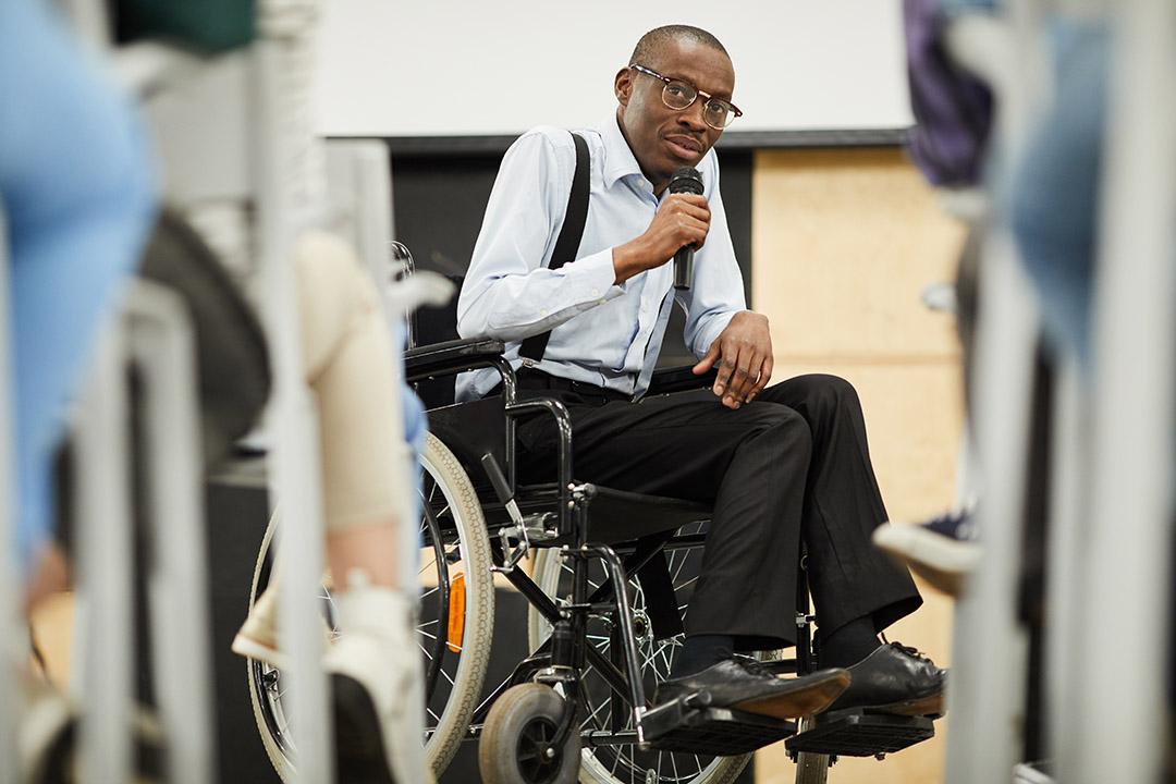 Self-advocate with disabilities speaking to a group about election reform.