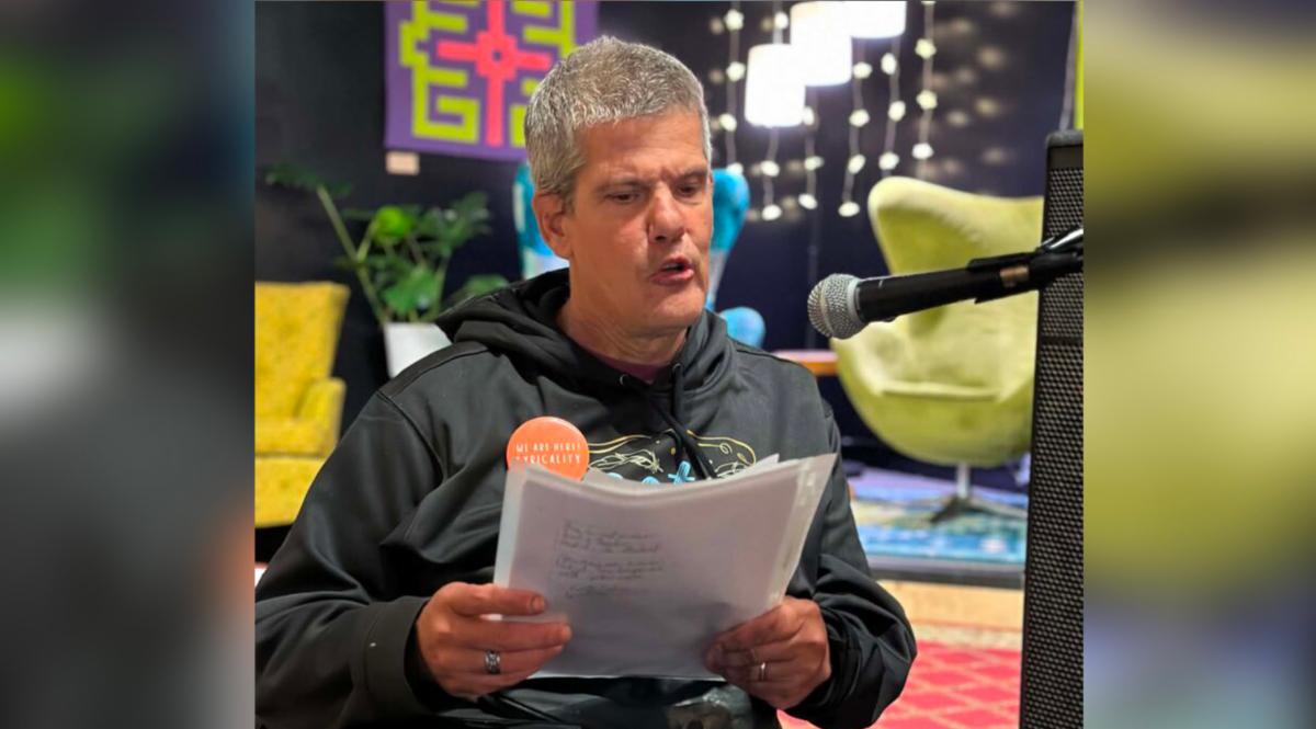 Keith, a self-advocate in Minnesota, is shown reading testimony regarding voting access before legislators.