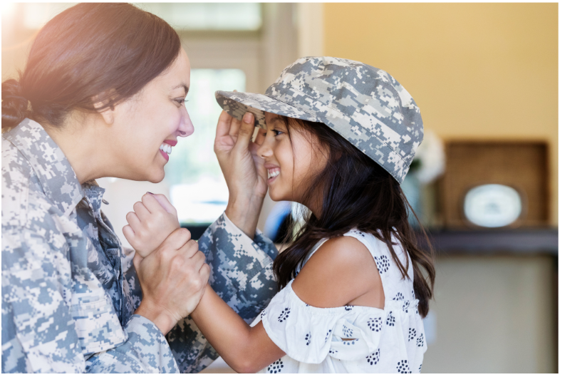 Mother in military fatigue with daughter. 