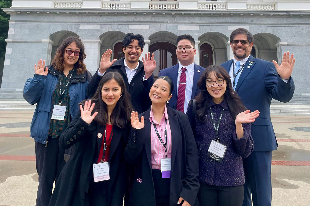 Seven representatives of student government in front of the Capitol Building in Sacramento.