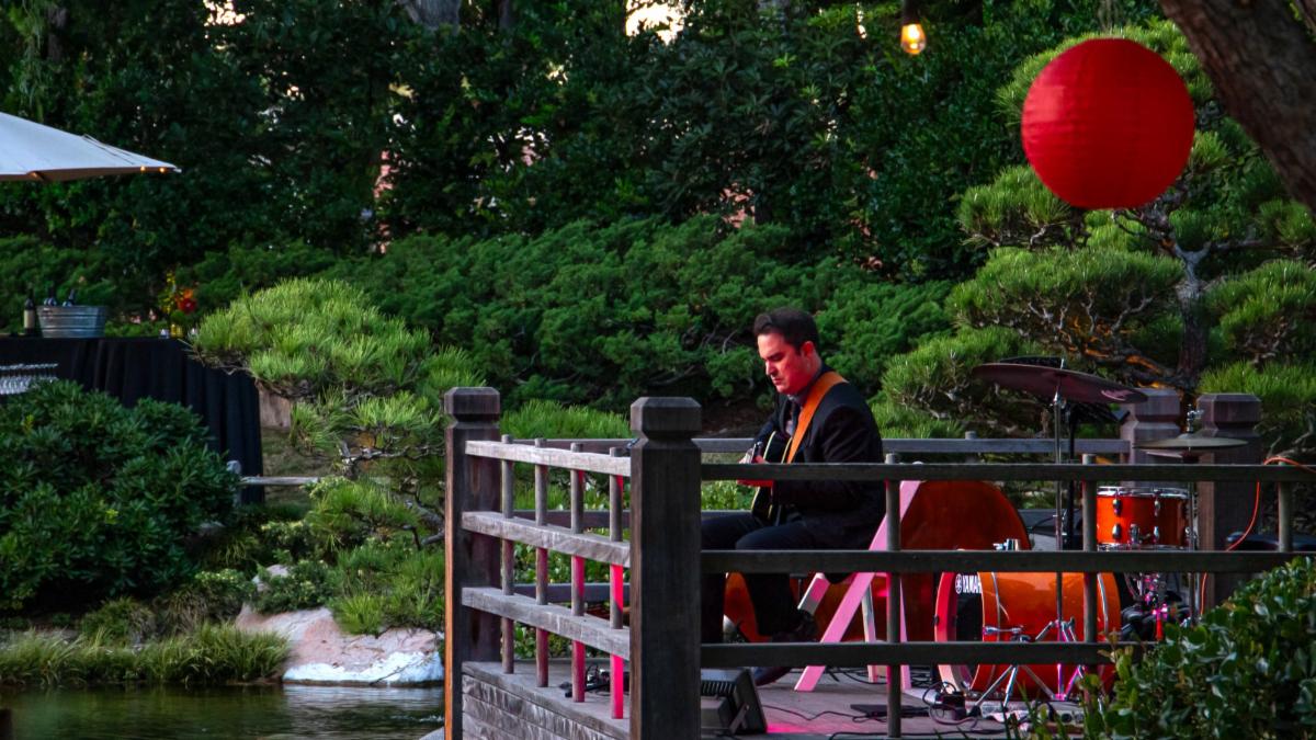 A musician performs in the Japanese Garden