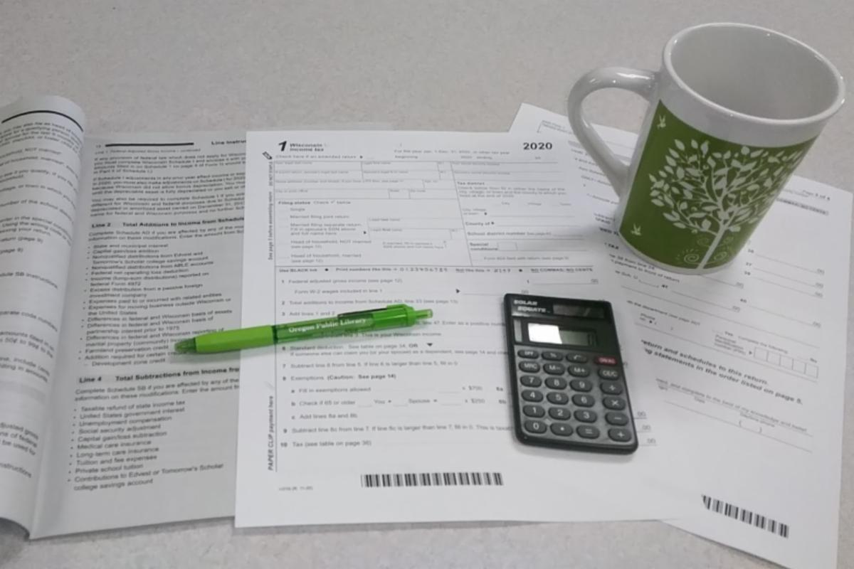 2020 taxes with calculator coffee cup and pen