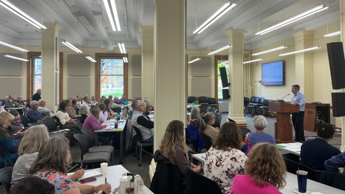 Attendees listening to a speaker at the 2025 Symposium