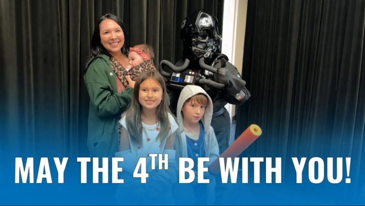A family posing with a character from Star Wars at the Torrance Library May 4th Event