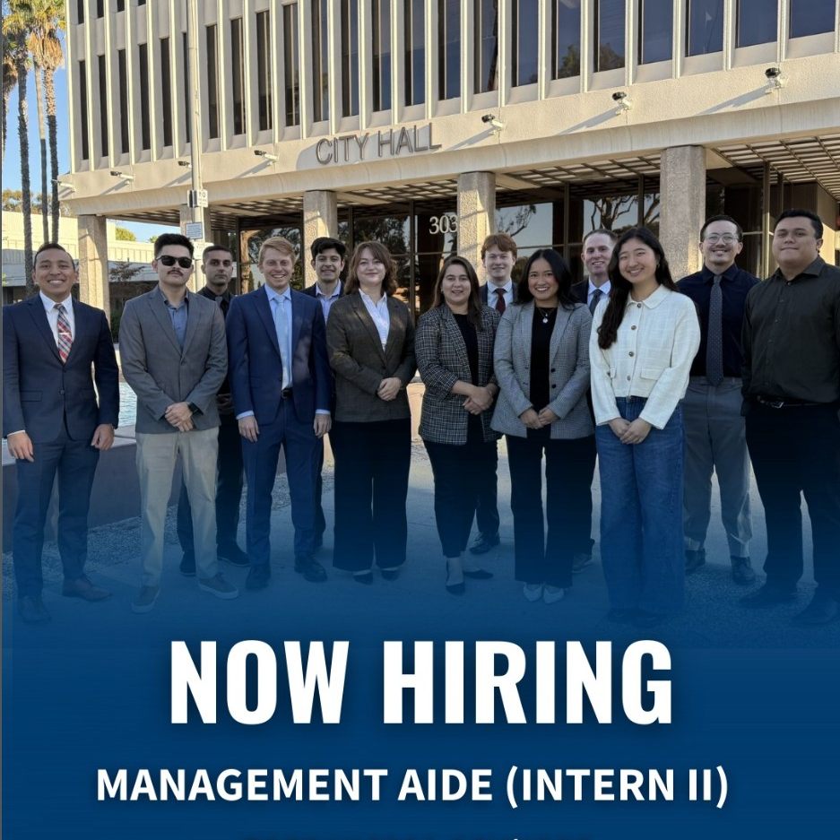 Group Picture of Management Interns in front of City Hall with Now Hiring text in foreground