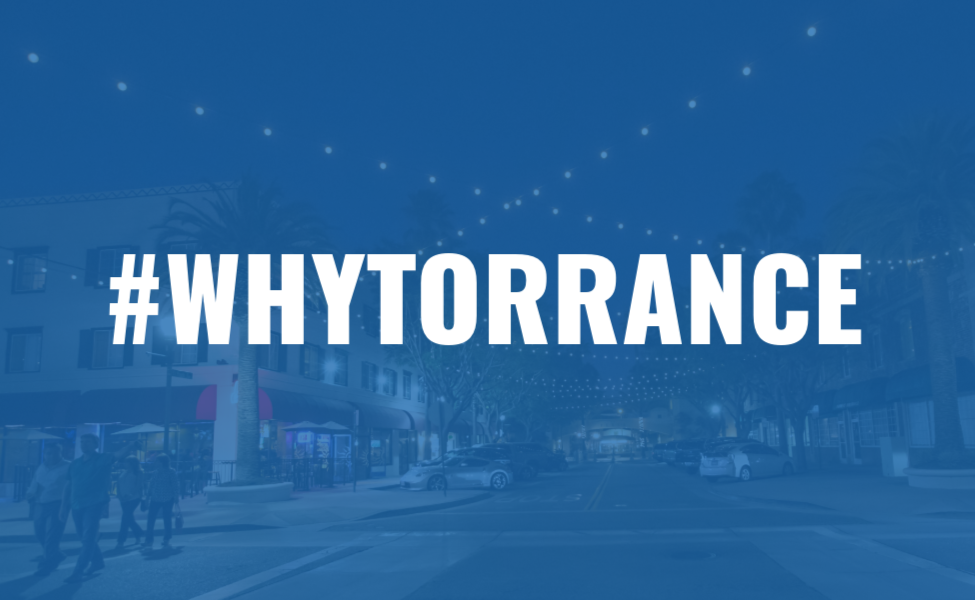 Downtown Torrance at night with a blue overlay and the text '#WHYTORRANCE' in white bold letters at the top. This image is a hyperlink to the 'Why Torrance' website.