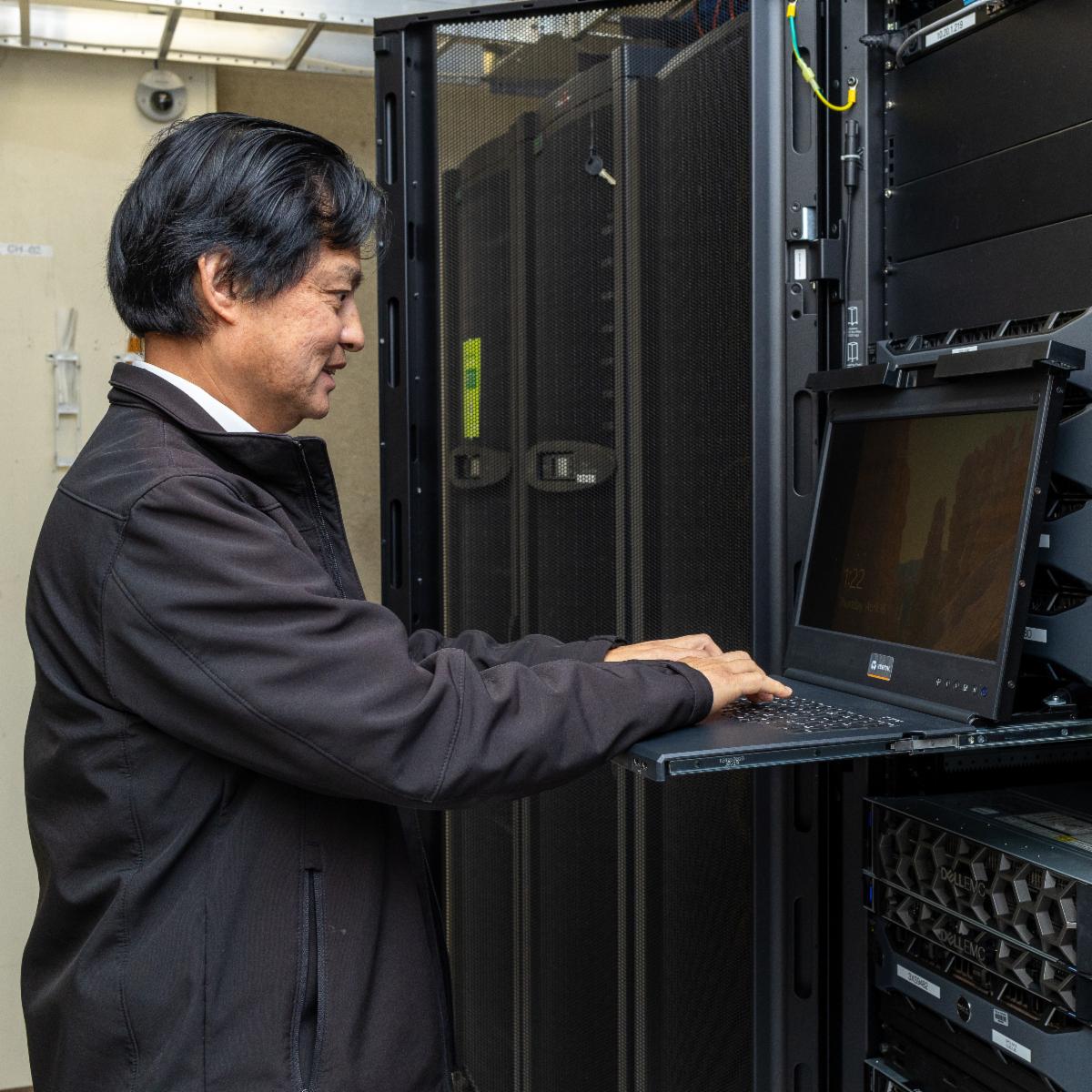 Member of our Information Technology working on a laptop