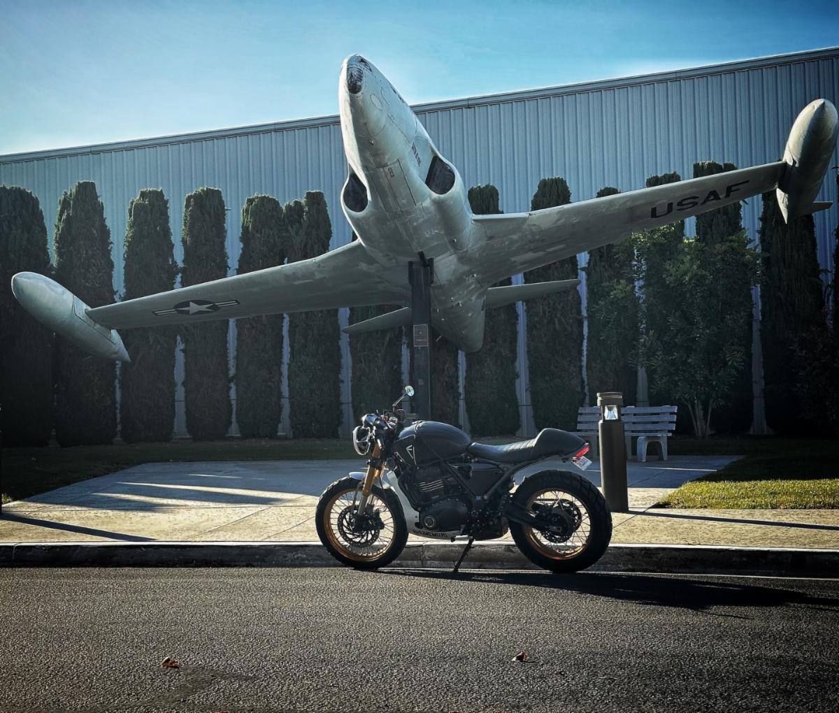 Motorcycle in front of a status of a Plane at Zamperini Airport 
