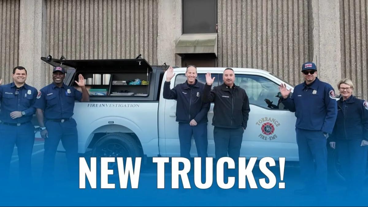 New Trucks text in foreground with personnel and vehicle in the background