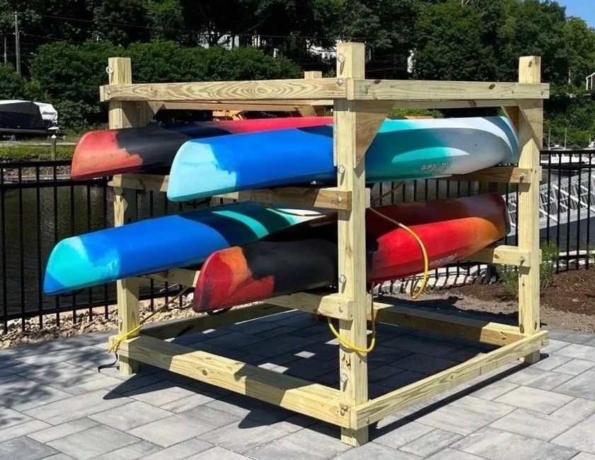 Kayaks stored on a wooden outdoor shelf