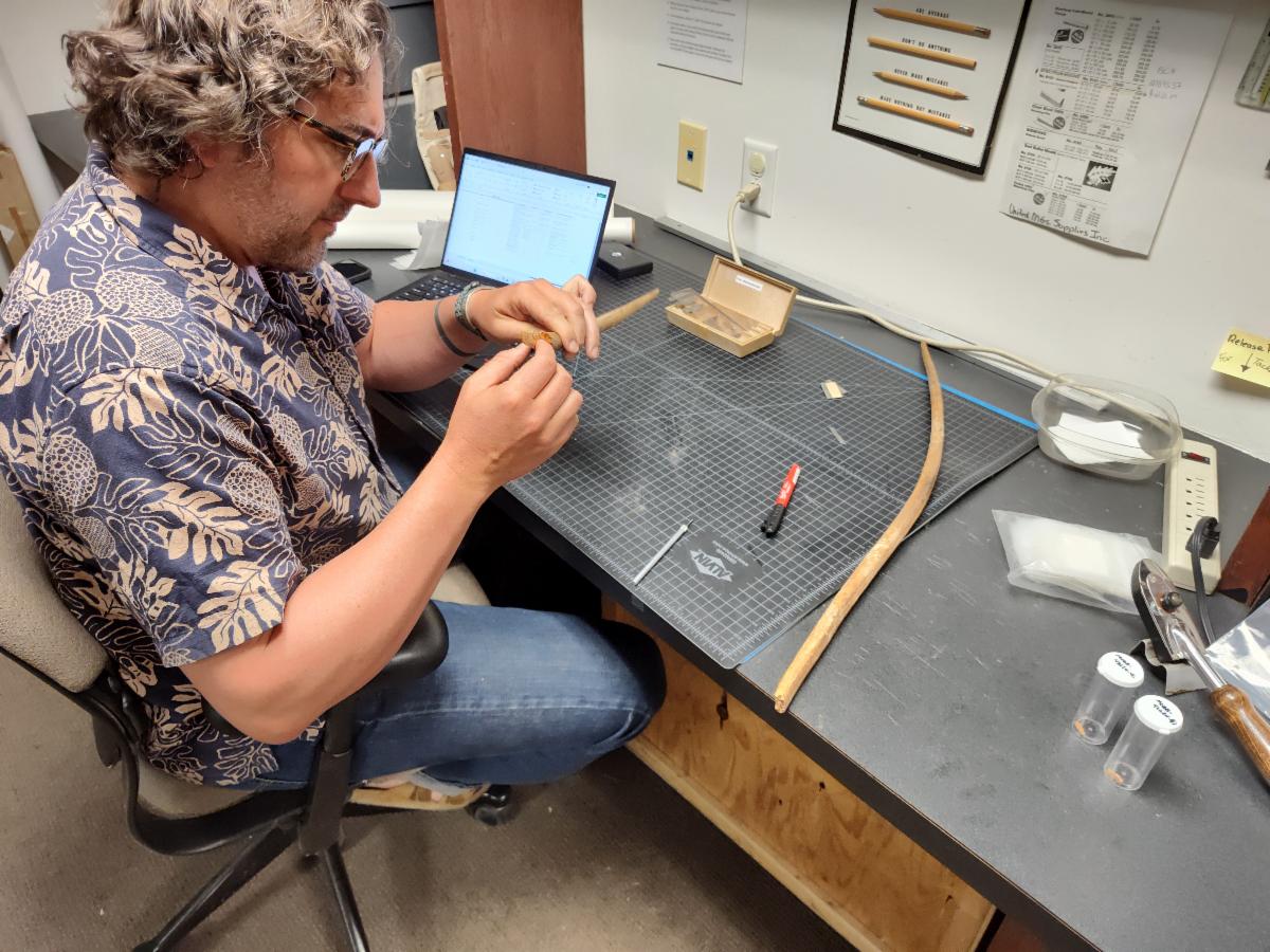 Dr. Bryon Shroeder looking at perishable artifacts from the Museum of the Big Bend. 