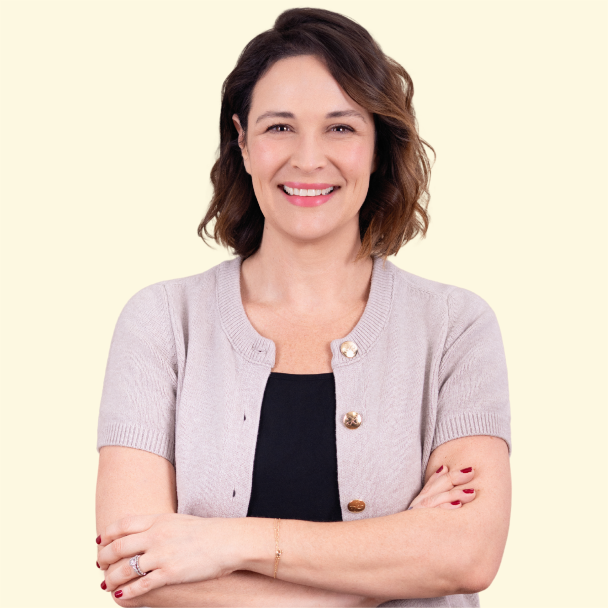 Profile image of Kristen smiling with her arms crossed. 
