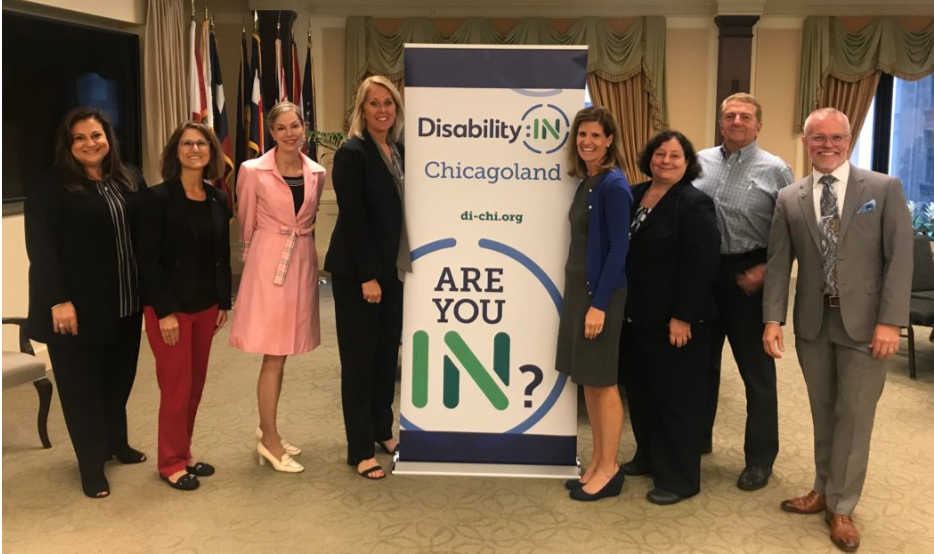 Chicagoland Executive Director Laura Wilhelm stands with her Board members with the Affiliate of the Year banner in the background