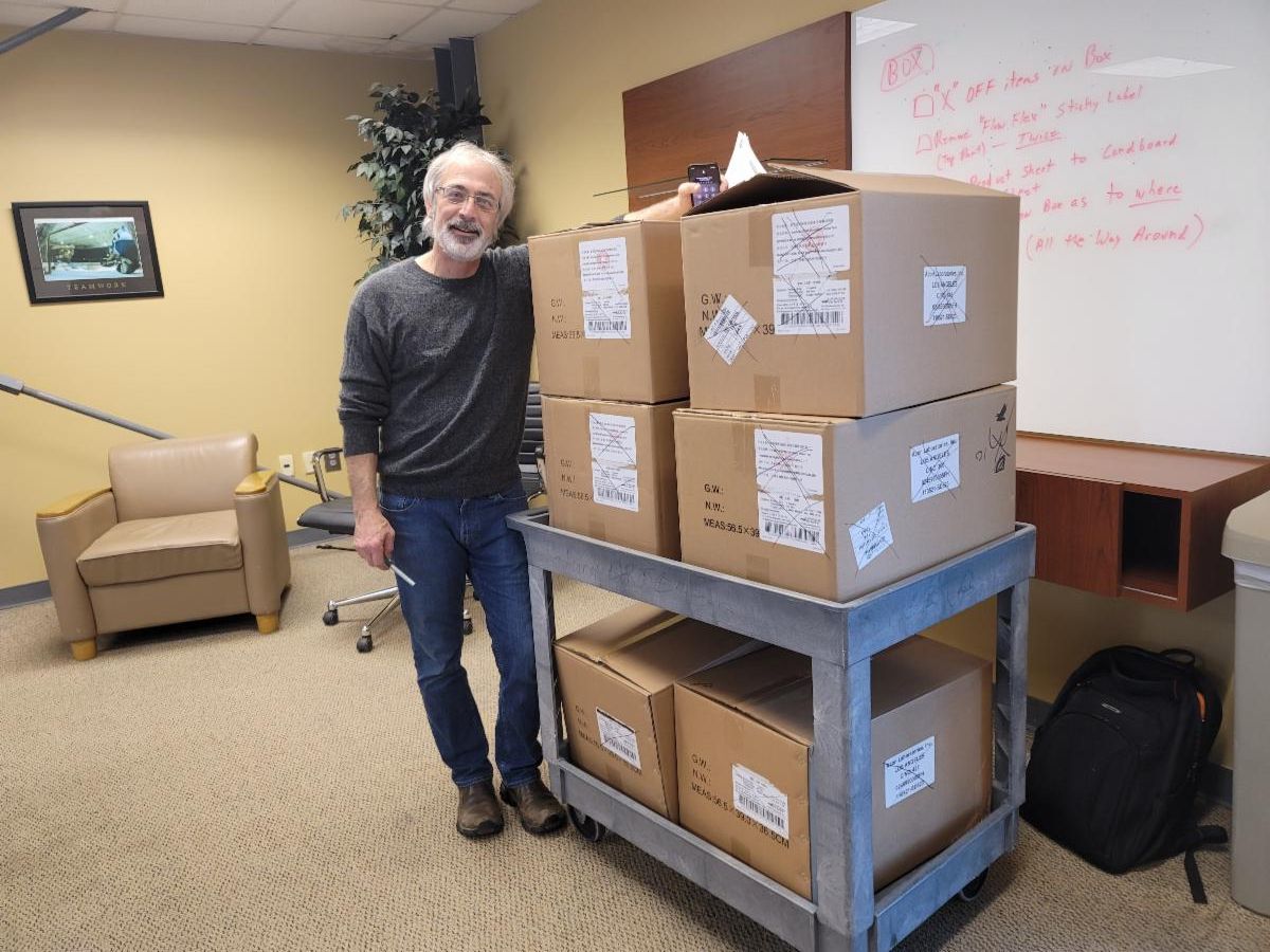 Scott with Covid Test Kits.jpg