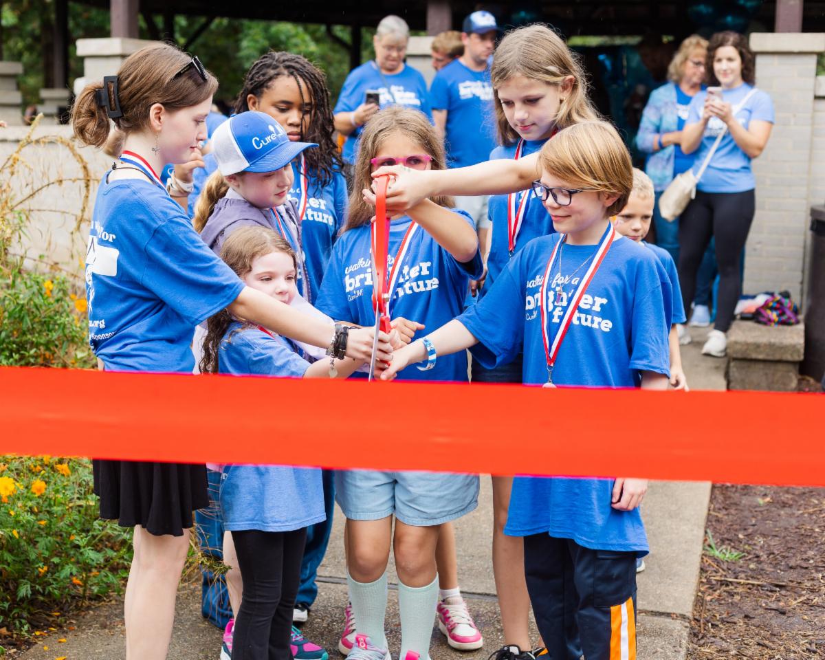 Cure JM kids cutting ribbon at Walk Strong to Cure JM event.