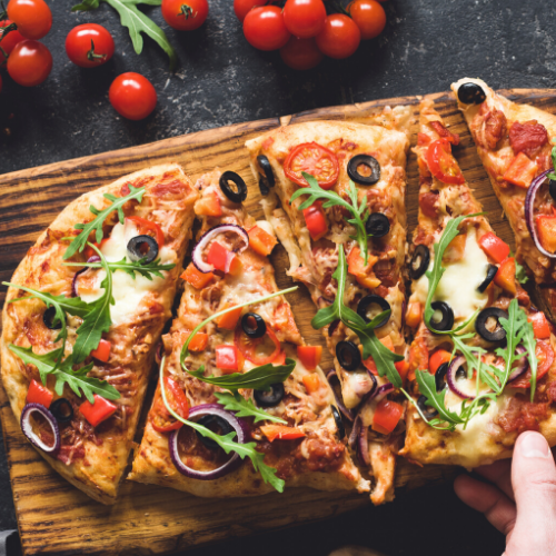 Flatbread pizza with onions_ tomatoes_ arugula and olives