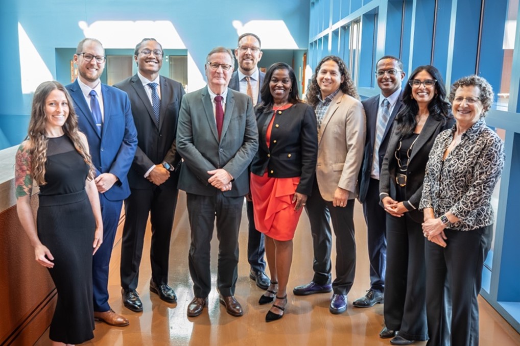 Group photo taken in a well-lit indoor space of UCSF Chancellor Sam Hawgood with Vice Chancellor Renee Navarro and the 2025 award recipients. 