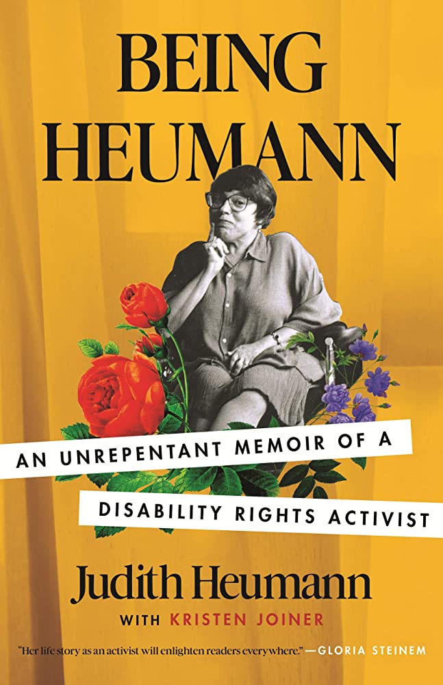 Yellow book cover of "Being Heumann" written by Judith Heumann with Kristen Joiner. The cover features a black & white image of Judith smiling at the camera and colorful flowers surrounding her.