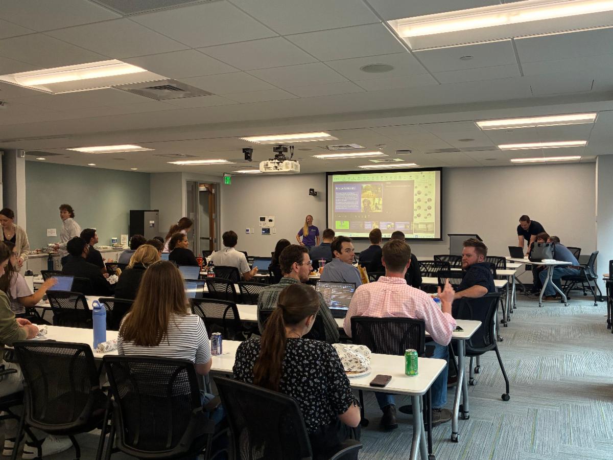 A full classroom listening to a presentation. 