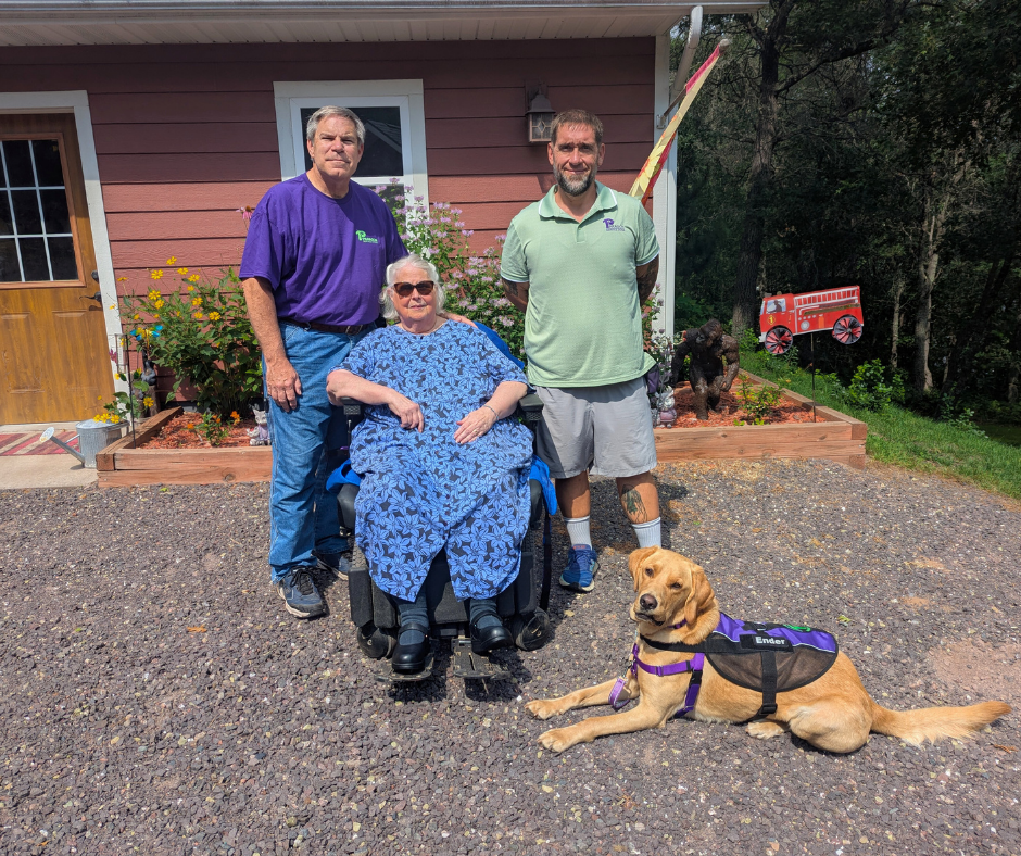 Client Cathy, her husband, and Paragon trainer Jack pose with Ender a golden lab mix. 