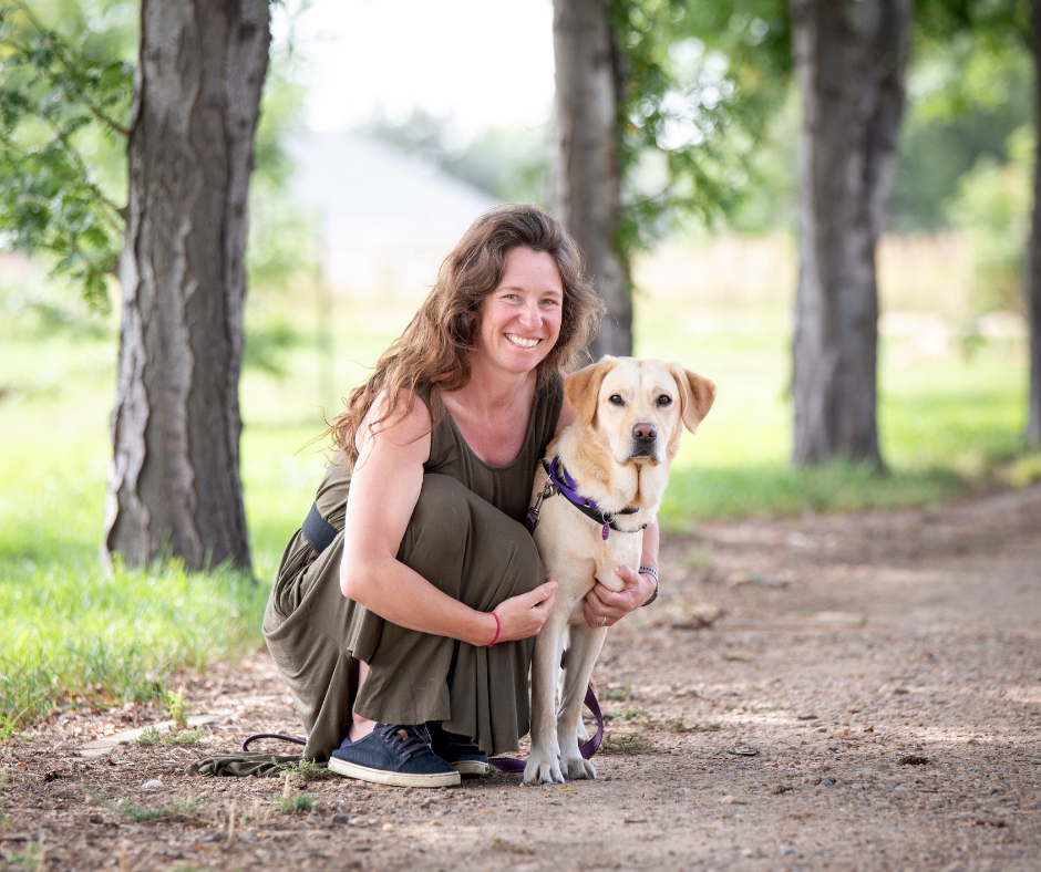 A professional photo of Christina in a green dress shows her hugging Danny her yellow Lab who stands at her side.