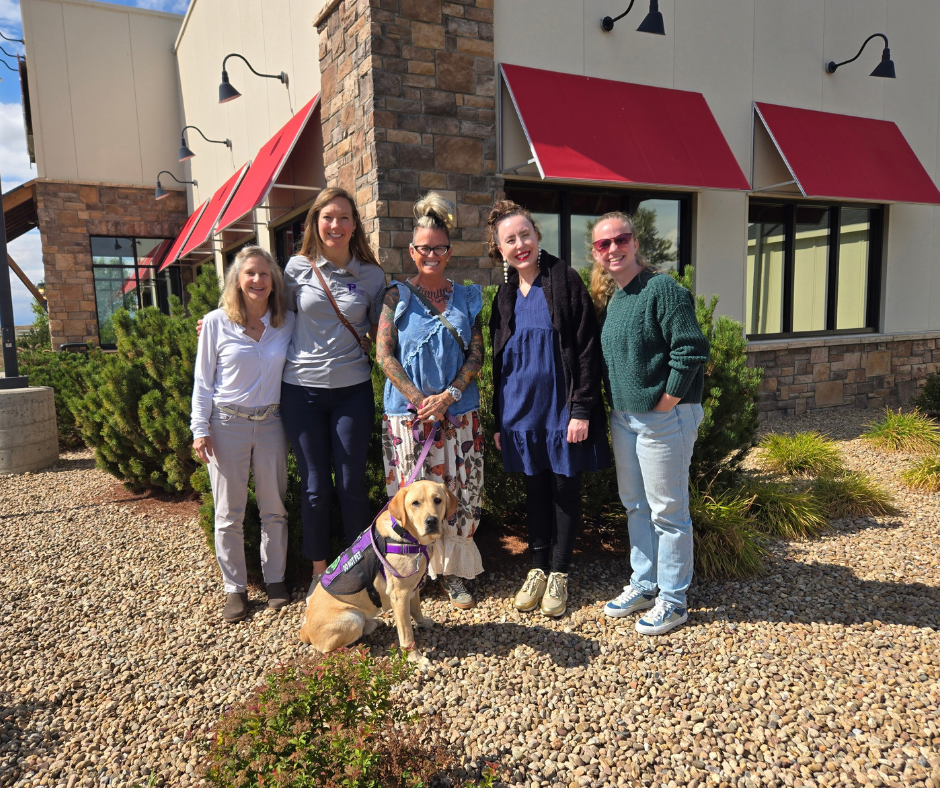 Fortune's dog trainer, his two weekend companions, Paragon staff, and Melissa stand with Fortune for a group photo,.